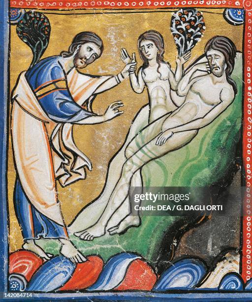 The Book of Genesis: the creation of Eve from Adam's rib, miniature from the Bible of Souvigny, Latin manuscript 1 folio 4 verso, 12th Century.