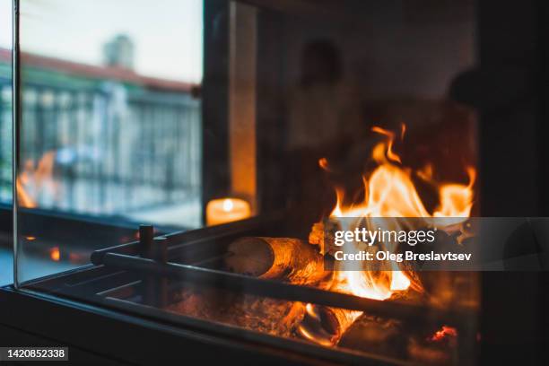 fireplace at home. burning fire close up. no people, background with copy space. - fogueira imagens e fotografias de stock