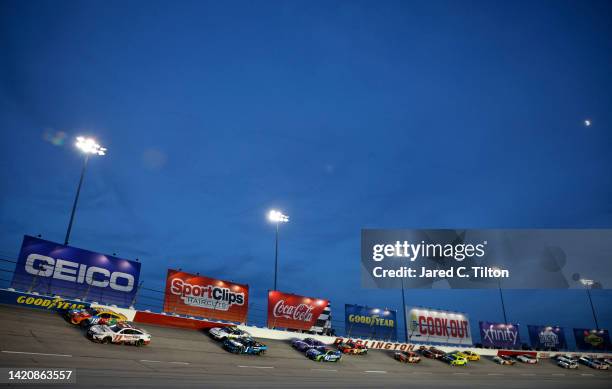 Denny Hamlin, driver of the Sport Clips Haircuts Toyota, and Kyle Busch, driver of the M&M's Toyota, lead the field during the NASCAR Cup Series Cook...