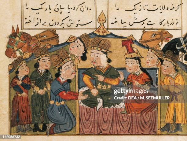 Genghis Khan seated on his throne with his wife under a tent with four Mongols and camels, miniature from Mongolian History in Verse, Persia 15th...