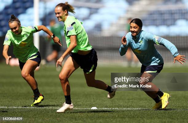 Caitlin Foord, Emily Van Egmond and Sam Kerr run during an Australia Matildas training session at Allianz Stadium on September 05, 2022 in Sydney,...