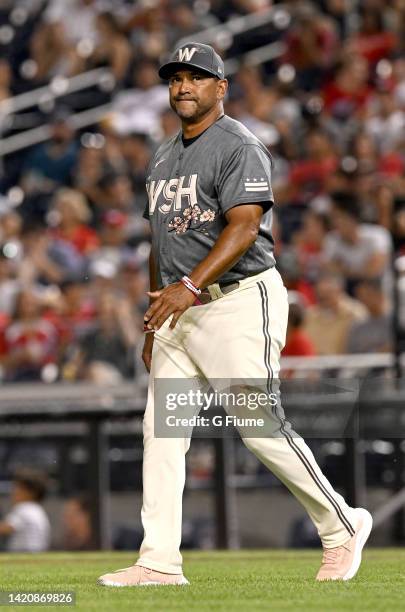 Manager Dave Martinez of the Washington Nationals walks across the field during the game against the Cincinnati Reds at Nationals Park on August 27,...