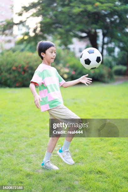 boy with soccer ball - all people stock pictures, royalty-free photos & images