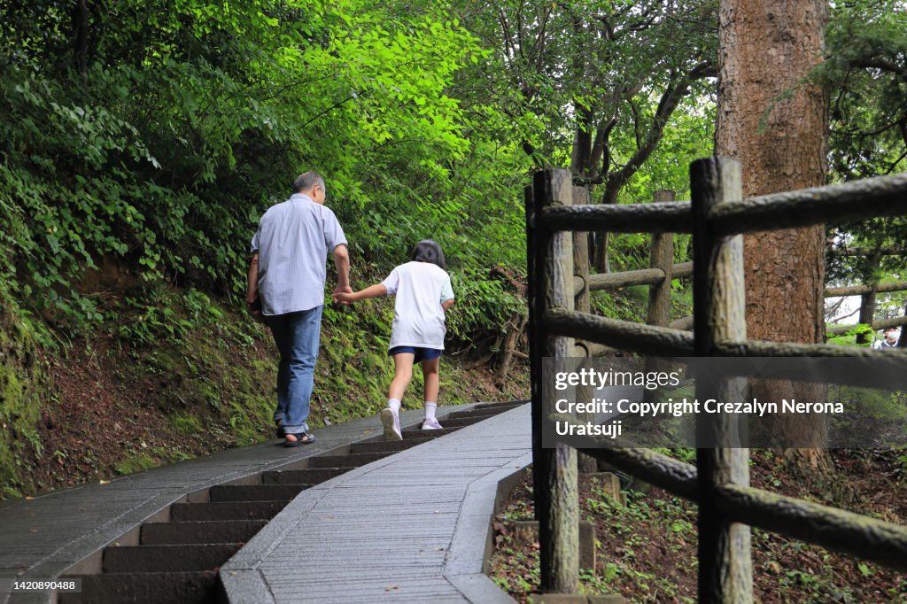 Father and Child Bonding Together,Going Travel. Holding Hands while Walking Upstairs in Matsushima