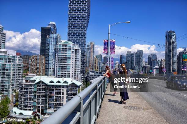 young woman on granville bridge on canada day, vancouver, canada - vancouver canada day stock pictures, royalty-free photos & images