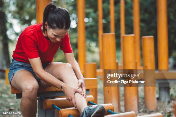 caucasian woman having an accident at the playground outside - sprain stock pictures, royalty-free photos & images
