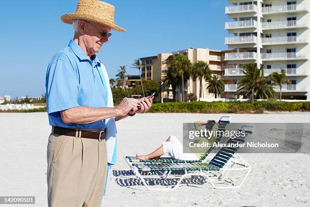 seniors using digital device, smart phone. - siesta key stockfoto's en -beelden