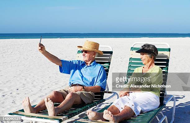 seniors using digital device - siesta key stock pictures, royalty-free photos & images