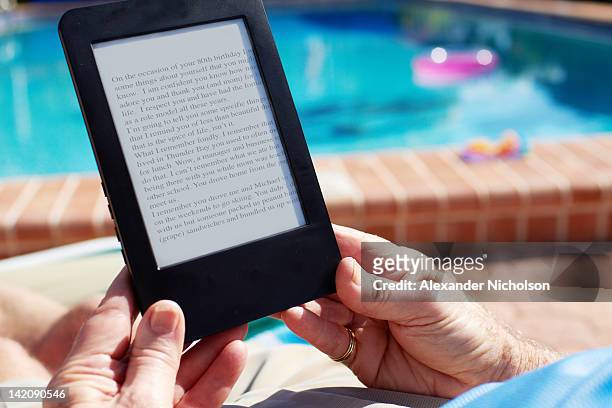 seniors using digital device - e reader stock pictures, royalty-free photos & images