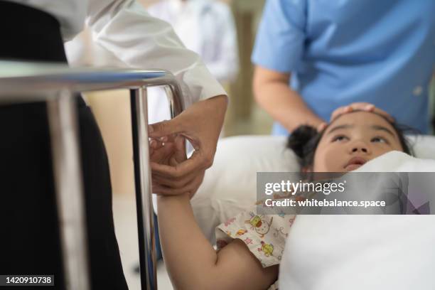 mother hand holding sick daughter hand with love and care. - patient bad news stock pictures, royalty-free photos & images