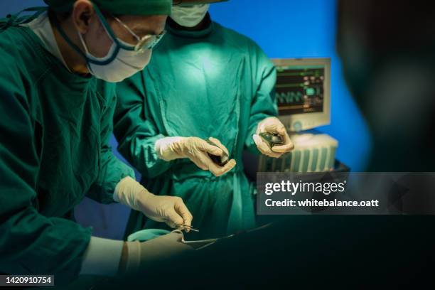 doctors using virtual reality glasses are surgery to patient at operating room. - performing arts event stockfoto's en -beelden