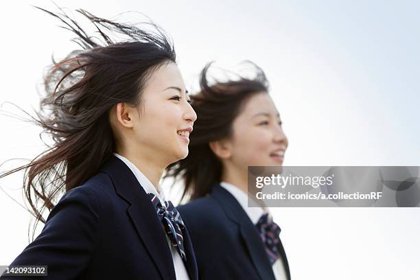 two high school girls running - studentessa di scuola secondaria foto e immagini stock