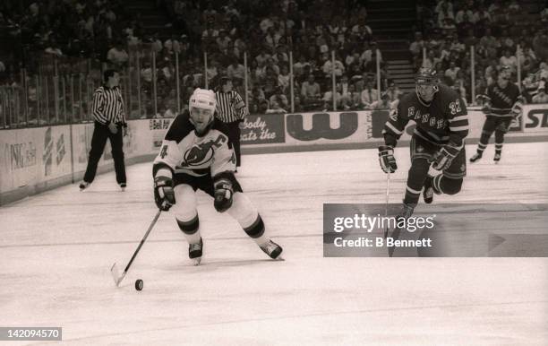 Scott Stevens of the New Jersey Devils skates down the puck as Stephane Matteau of the New York Rangers follows behind during Game 6 of the Eastern...