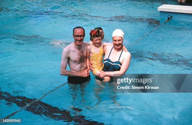 family in swimming pool - women swimming pool retro stock pictures, royalty-free photos & images