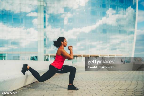 sportwoman in barcelona exercising in the city - crouch stock pictures, royalty-free photos & images