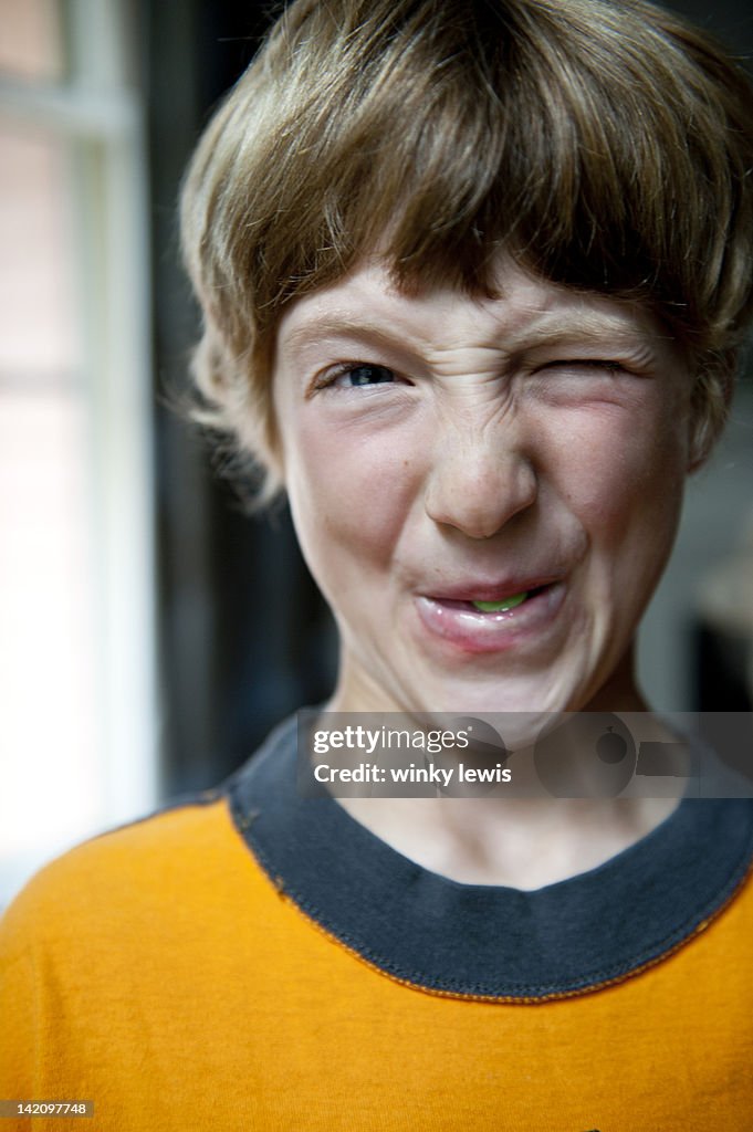 Boy eats a sour candy