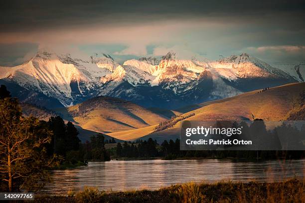 a beautiful river and mountain range at sunset in montana. - missoula stock pictures, royalty-free photos & images