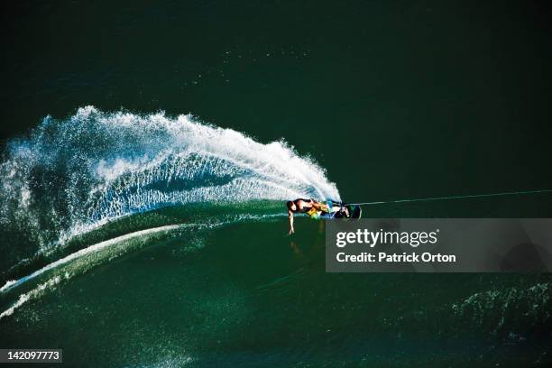 a athletic wakeboarder carves and slashes on a calm day in idaho. shot from above. - idaho stock-fotos und bilder