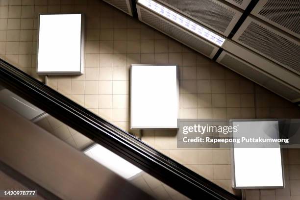 three blank vertical billboard poster in the subway station - blank placard stock pictures, royalty-free photos & images