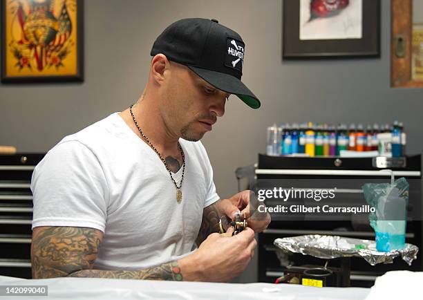 Tattoo artist Ami James prepares to tattoo lead singer Camilla Romestrand of the UK rock band Eddie The Gun at the Wooster Street Social Club on...
