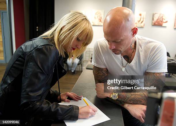 Lead singer Camilla Romestrand of the UK rock band Eddie The Gun discusses a tattoo design with tattoo artist Ami James to promote the release of the...