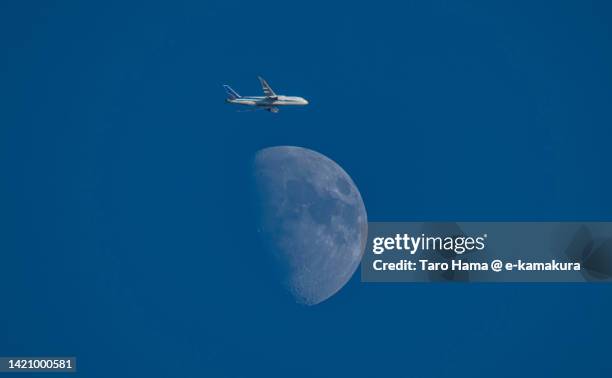 the flying airplane and moon over kanagawa of japan - tokyo international airport foto e immagini stock