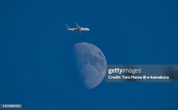 the flying airplane and moon over kanagawa of japan - tokyo international airport ストックフォトと画像