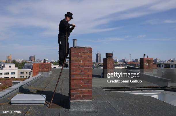 Chimney sweep Norbert Skrobek takes a photo of a chimney opening on the roof of an apartment building on September 05, 2022 in Berlin, Germany....