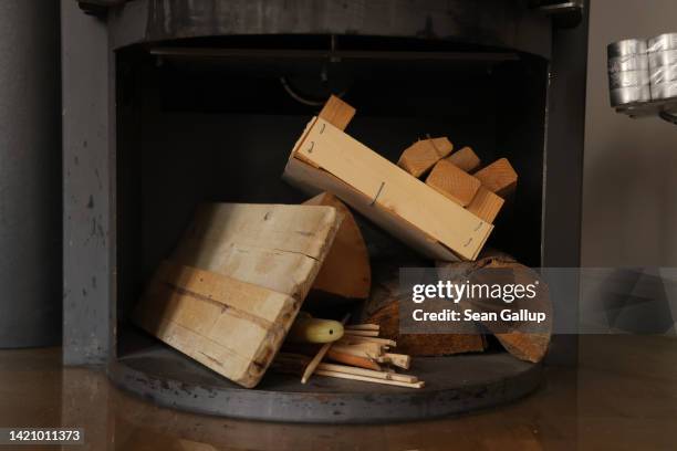 Firewood lies under a wood-burning stove that its owner is seeking to replace with a more modern and energy efficient model on September 05, 2022 in...