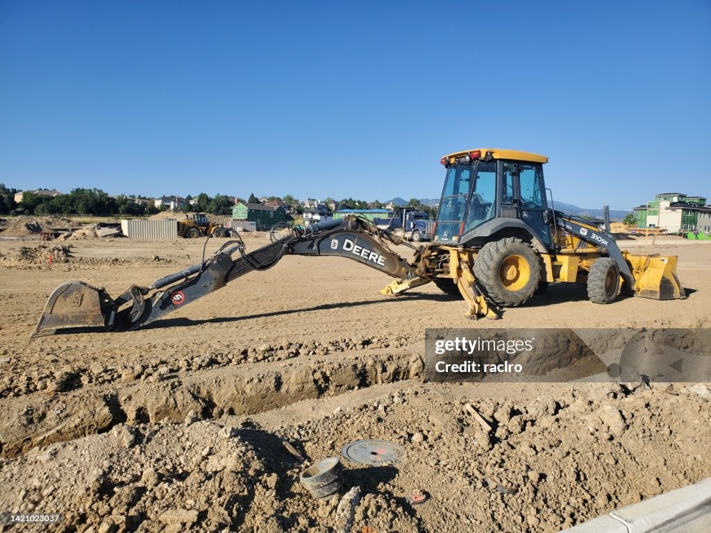 Backhoe Trenches John Deere Backhoe And A Pipeline Trench In A New Development High-Res ...
