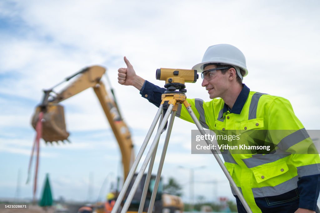 Male engineer and survey equipment check elevation for construction work