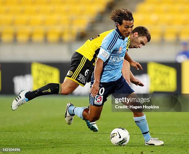 Nick Carle of Sydney FC is tackled by Tim Brown of the Phoenix during the A-League Elimination Final match between the Wellington Phoenix and Sydney...