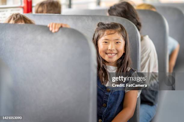 riding the school bus - kids sitting together in bus stock pictures, royalty-free photos & images