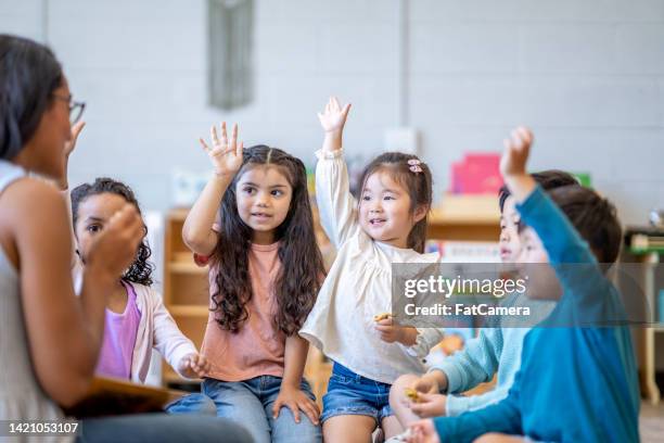 montessori students discovering together - preschool art stock pictures, royalty-free photos & images