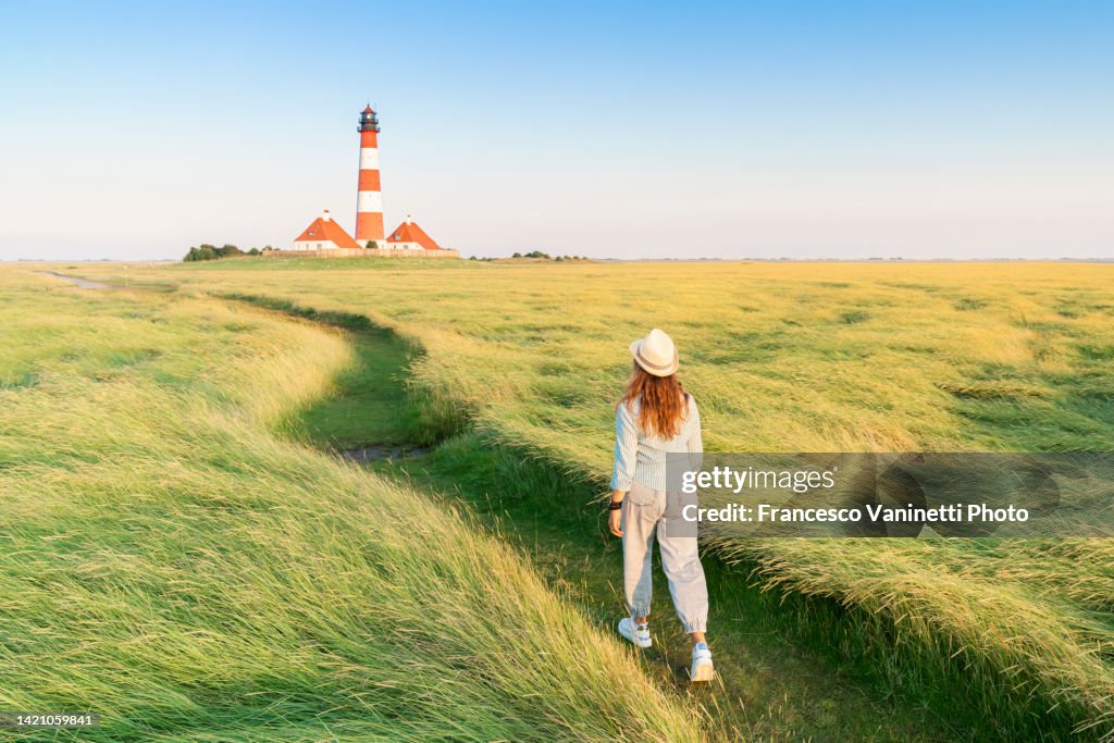 Woman at Westerheversand lighthouse, Germany.