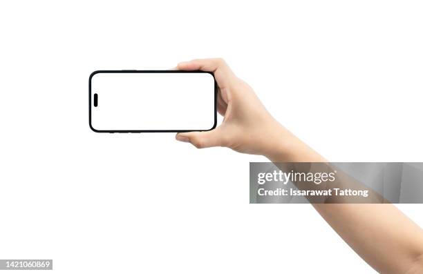 close up hand hold phone isolated on white background - hand holding mobile phone stock pictures, royalty-free photos & images