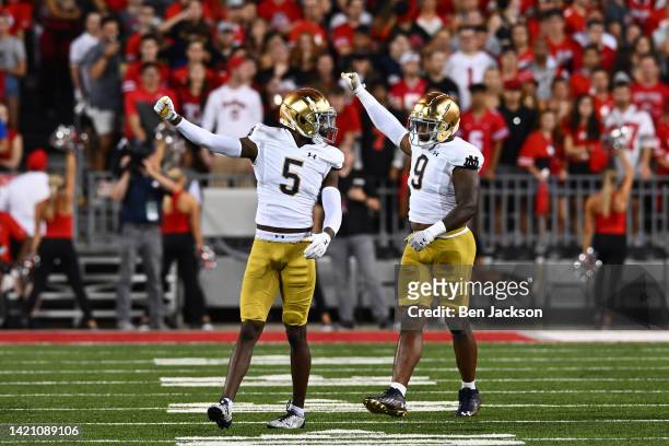 Cam Hart and Justin Ademilola of the Notre Dame Fighting Irish signal fourth down during the first quarter of a game against the Ohio State Buckeyes...