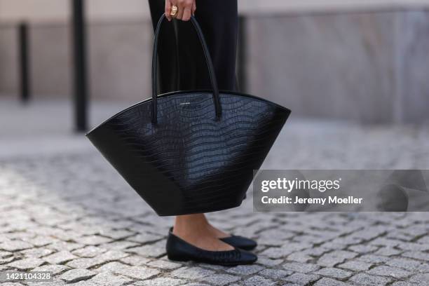 Aline Kaplan wearing Versace shades, Anine Bing bag, Massimo Dutti shirt, Joseph skirt, Tamaris shoes on August 31, 2022 in Berlin, Germany.