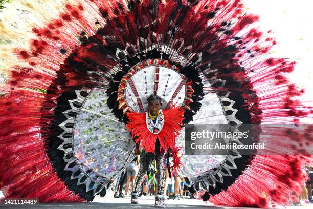 Man wearing a large feathered costume participates in the annual West Indian Day parade on September 5, 2022 in the Brooklyn Borough of New York...