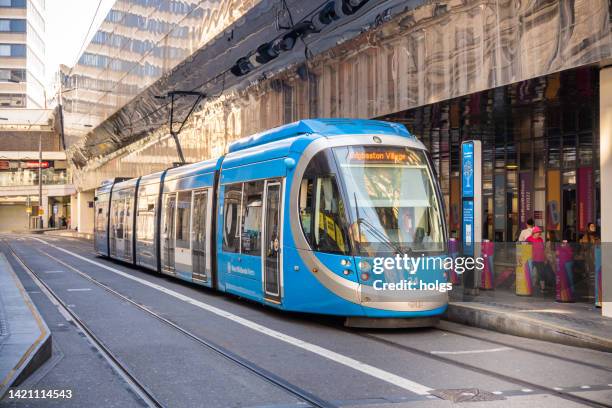 birmingham united kingdom tram stopped at the central train station with passengers visible next to the tram - lightrail stock pictures, royalty-free photos & images