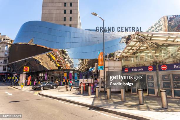 birmingham united kingdom central train station exterior with shiny clading. people can be seen on the street - birmingham uk stock pictures, royalty-free photos & images