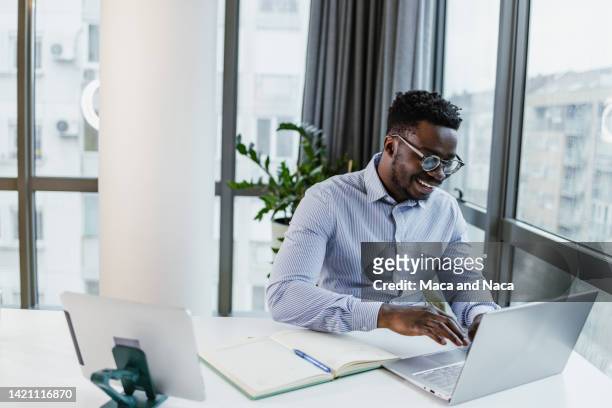 young businessman working at his office - businesswear stock pictures, royalty-free photos & images