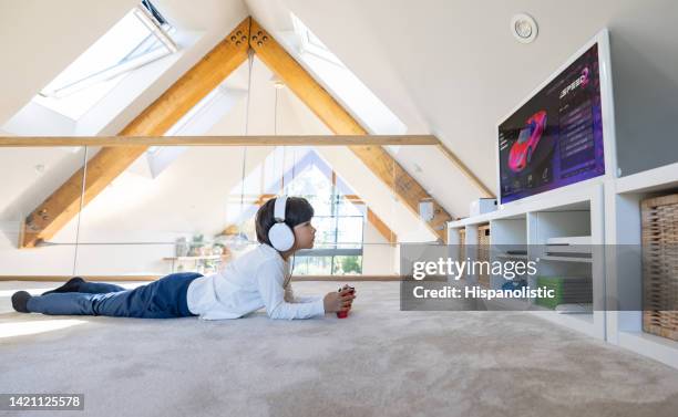 happy boy playing video games at home - child on carpet stock pictures, royalty-free photos & images