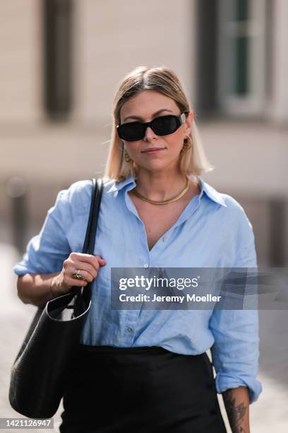 Aline Kaplan wearing Versace shades, Anine Bing bag, Massimo Dutti shirt, Joseph skirt, Tamaris shoes on August 31, 2022 in Berlin, Germany.