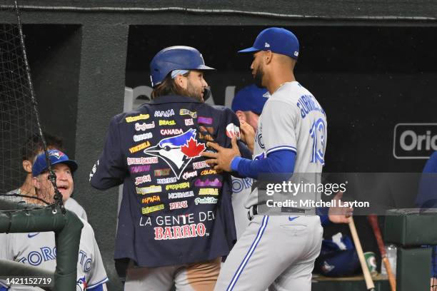 Bo Bichette of the Toronto Blue Jays is given the home run jacket by Lourdes Gurriel Jr. #13 after a solo home run in the seventh inning during game...