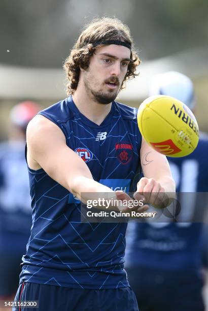 Luke Jackson of the Demons handballs during a Melbourne Demons AFL training session at Casey Fields on September 06, 2022 in Melbourne, Australia.