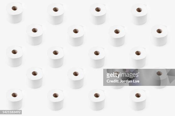 toilet rolls on white background - wrapped in toilet paper stock pictures, royalty-free photos & images