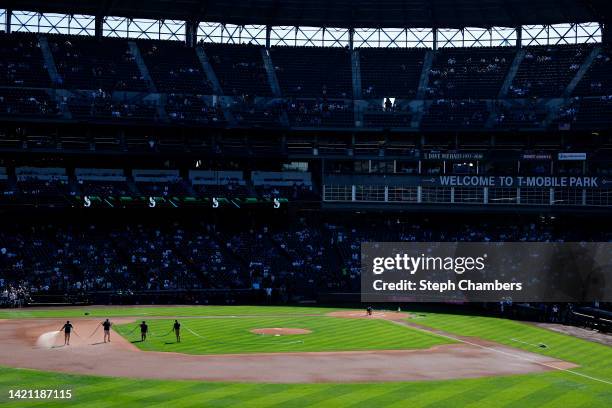 Grounds crew water the field before the game between the Seattle Mariners and the Chicago White Sox at T-Mobile Park on September 05, 2022 in...