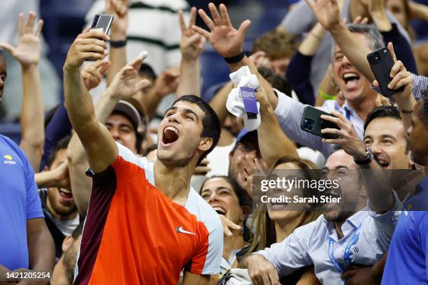 Carlos Alcaraz of Spain celebrates match point with fans against Marin Cilic of Croatia during their Men’s Singles Fourth Round match on Day Eight of...