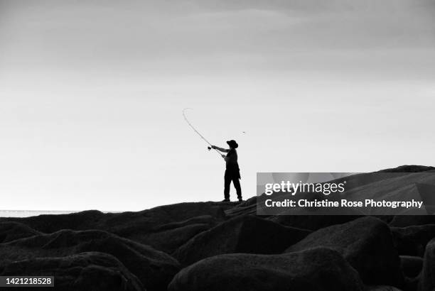 fishing on the rocks - copeland england stock pictures, royalty-free photos & images